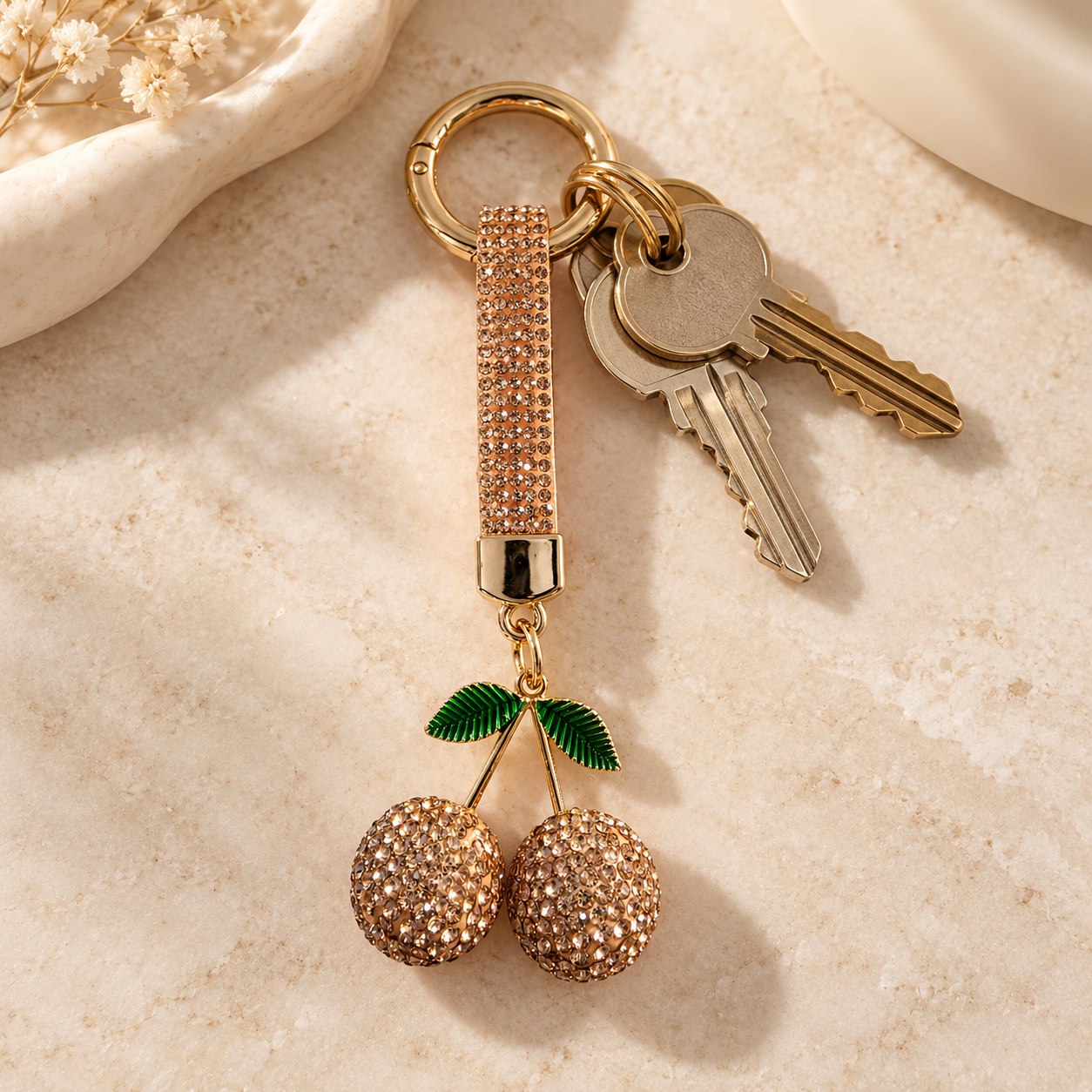Strass-sleutelhanger Kersen — champagne